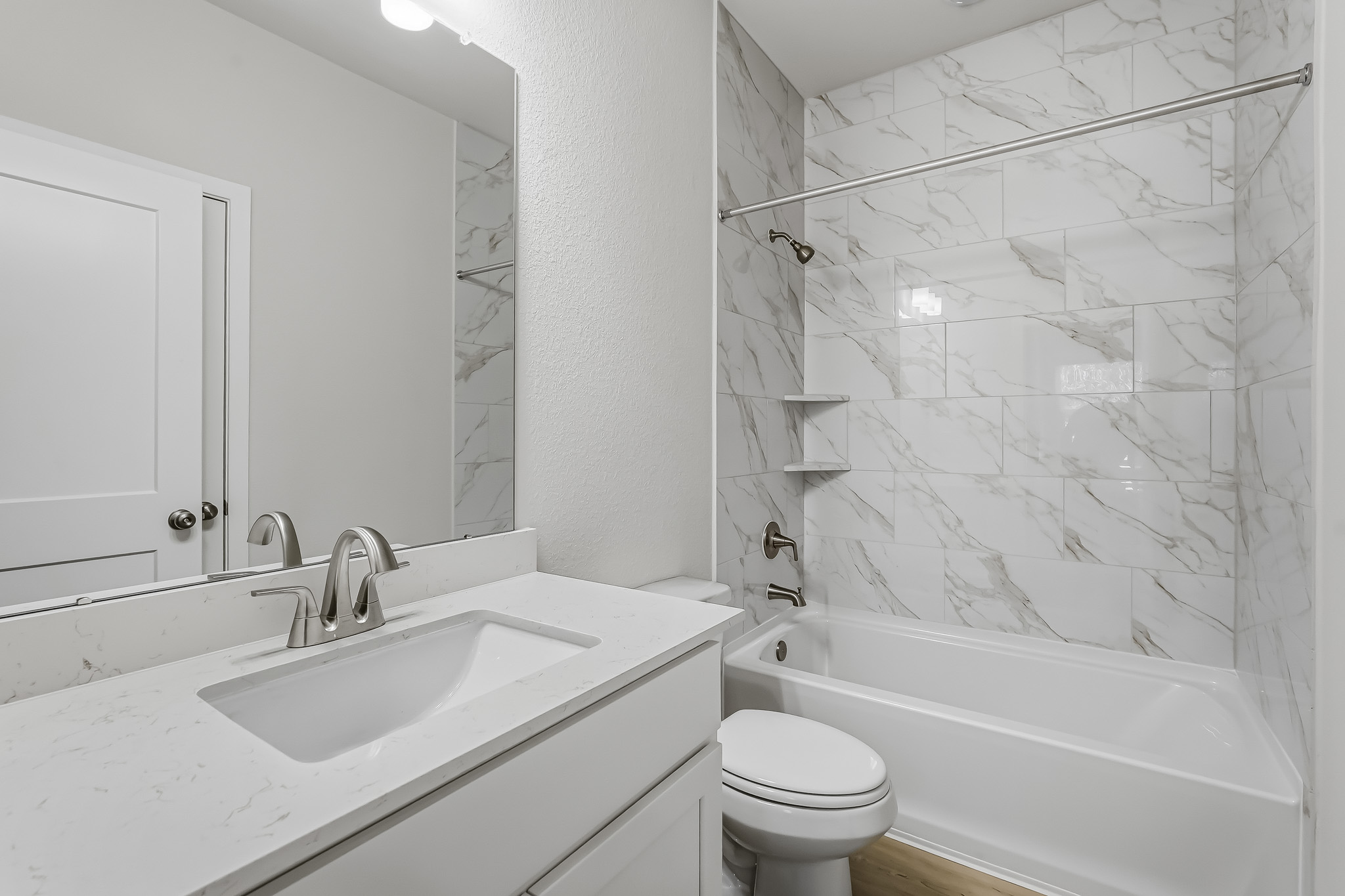 A bathroom with a sink and a toilet.