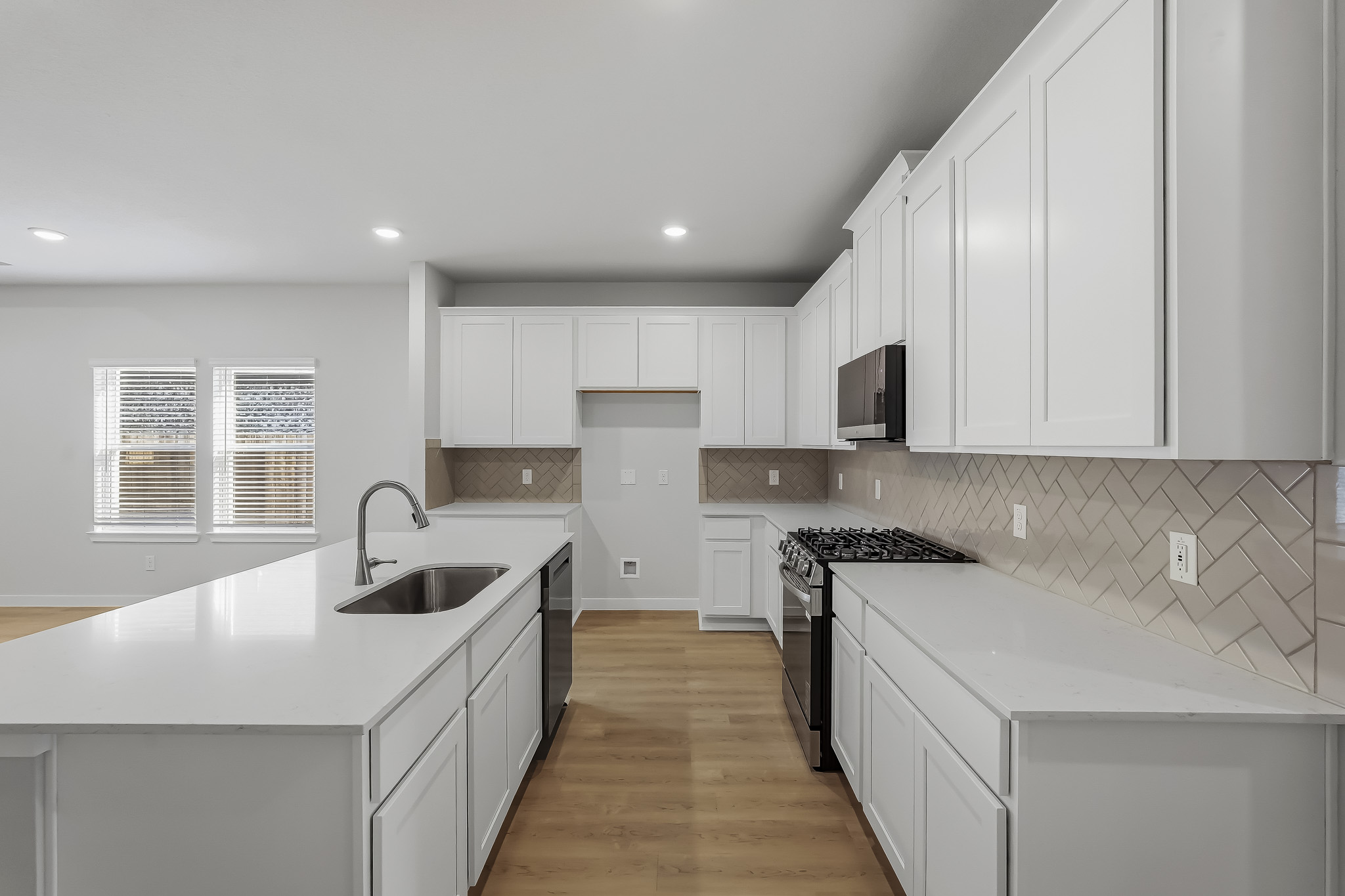A kitchen with white cabinets.