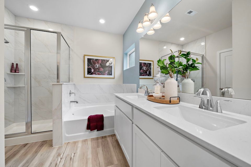 A bathroom with a tub sink and a shower.