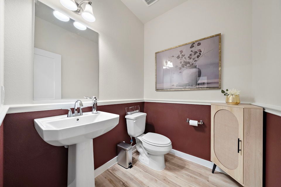 A bathroom with a sink and a mirror.