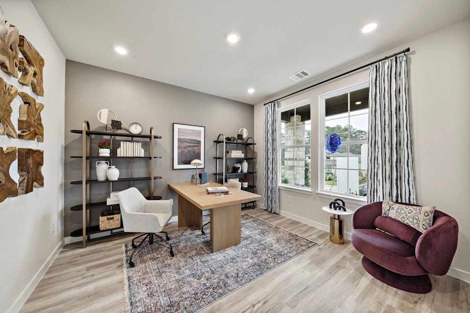A living room with a table and chairs.