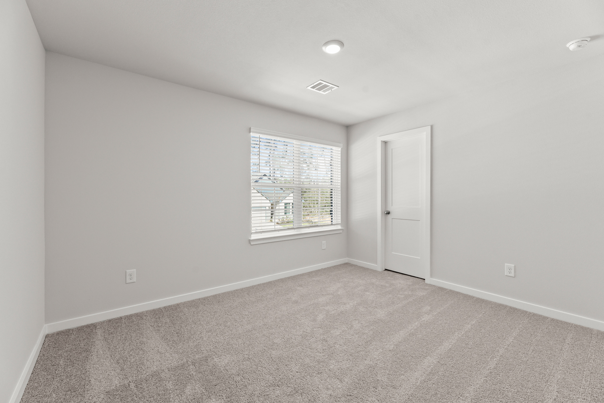 A room with a window and a door.