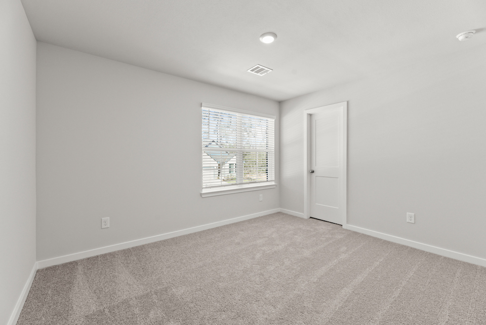 A room with a window and a door.