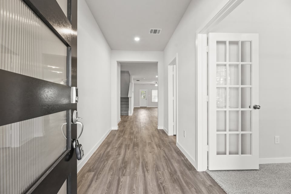 A hallway with white doors.