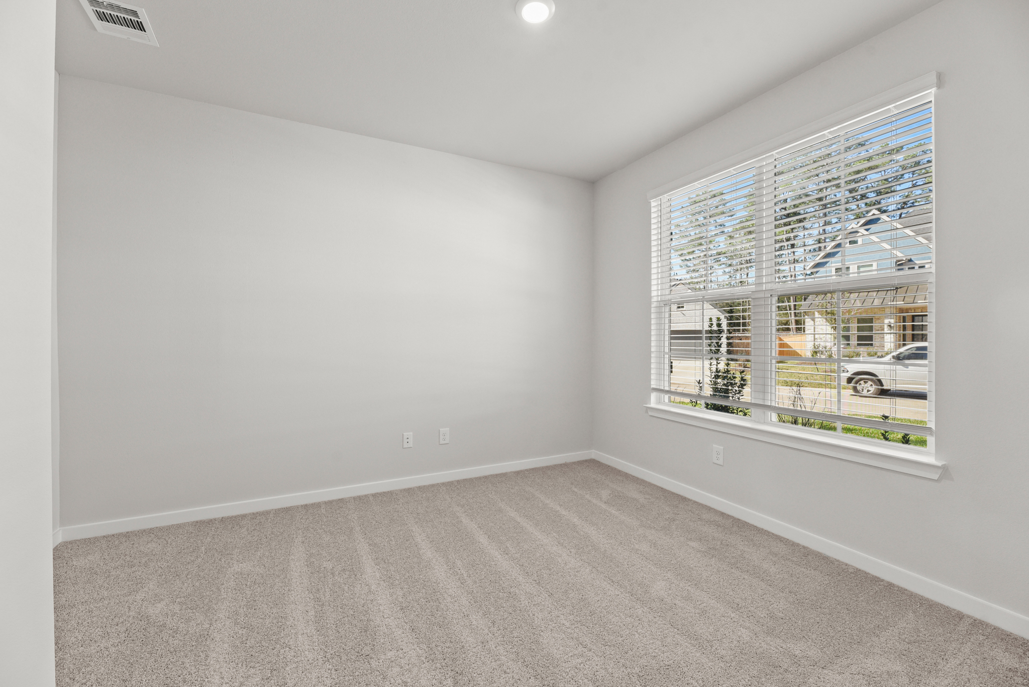 A room with a window and a car in it.