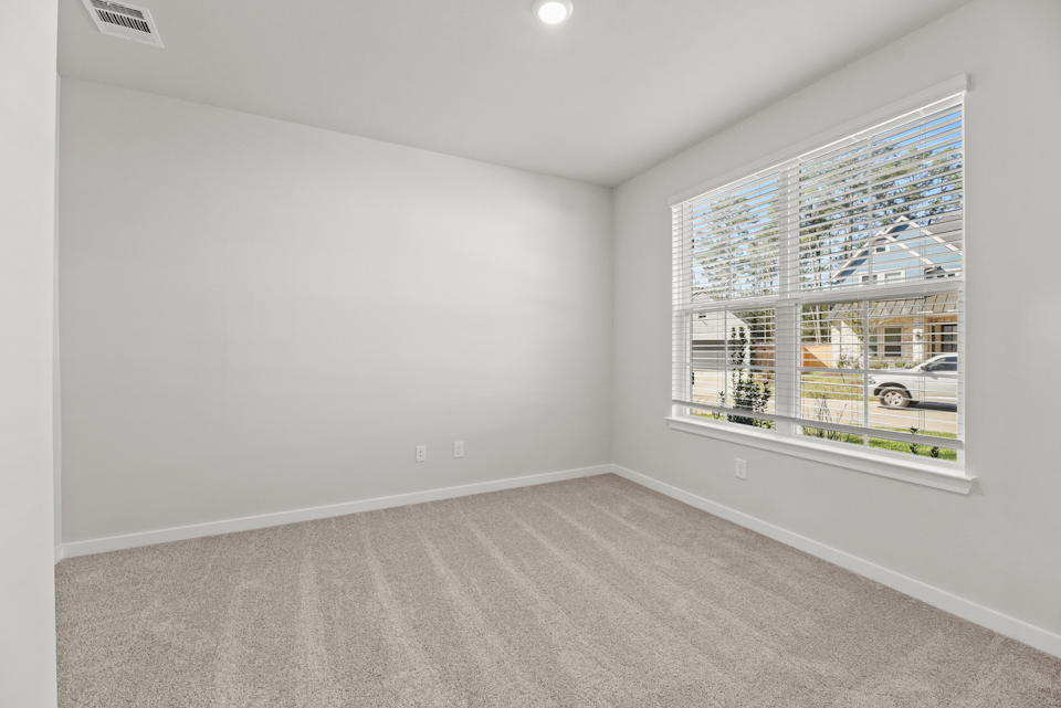 A room with a window and a car in it.