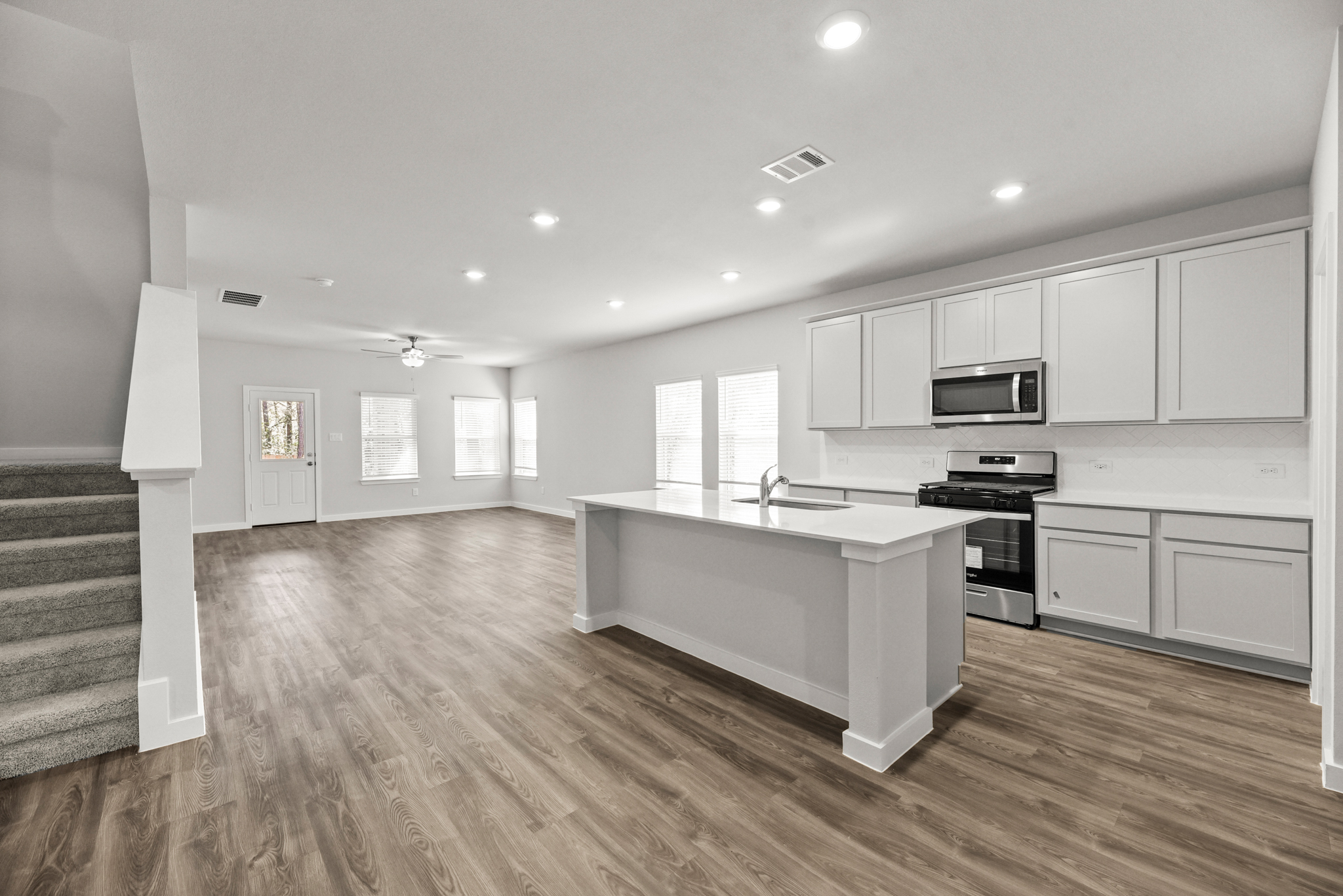 A kitchen with white cabinets.