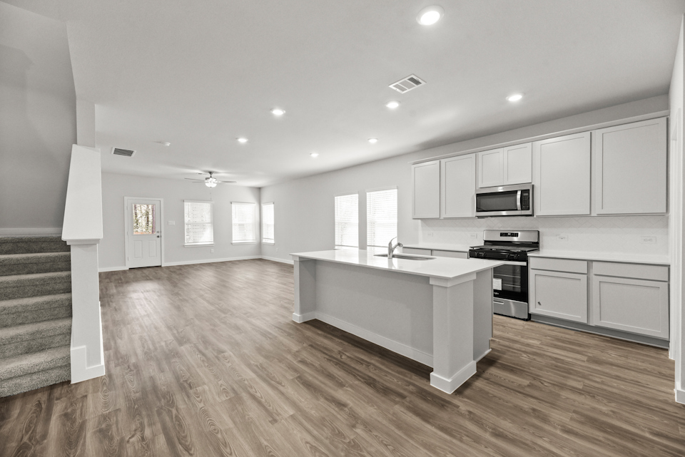 A kitchen with white cabinets.