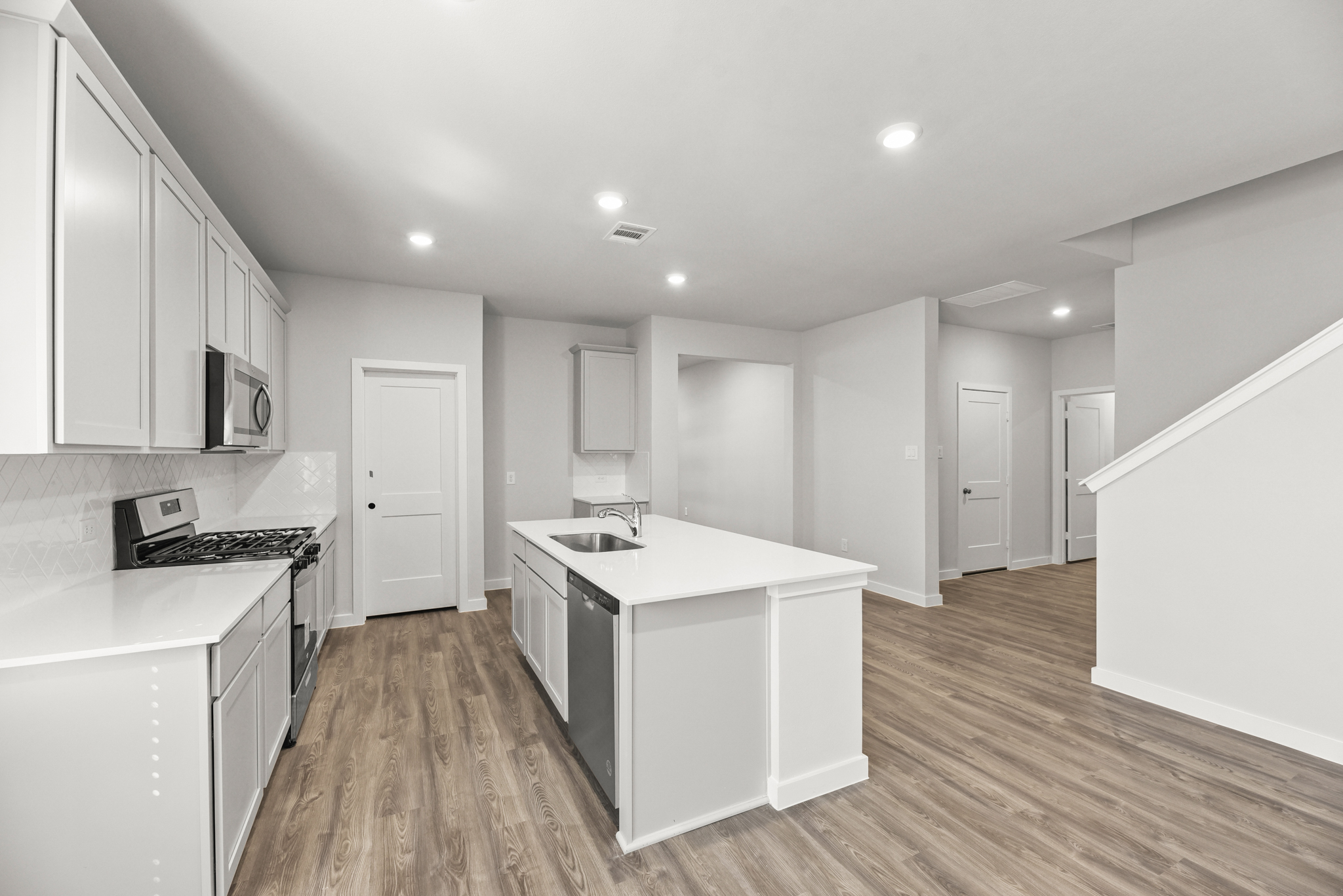A kitchen with white cabinets.