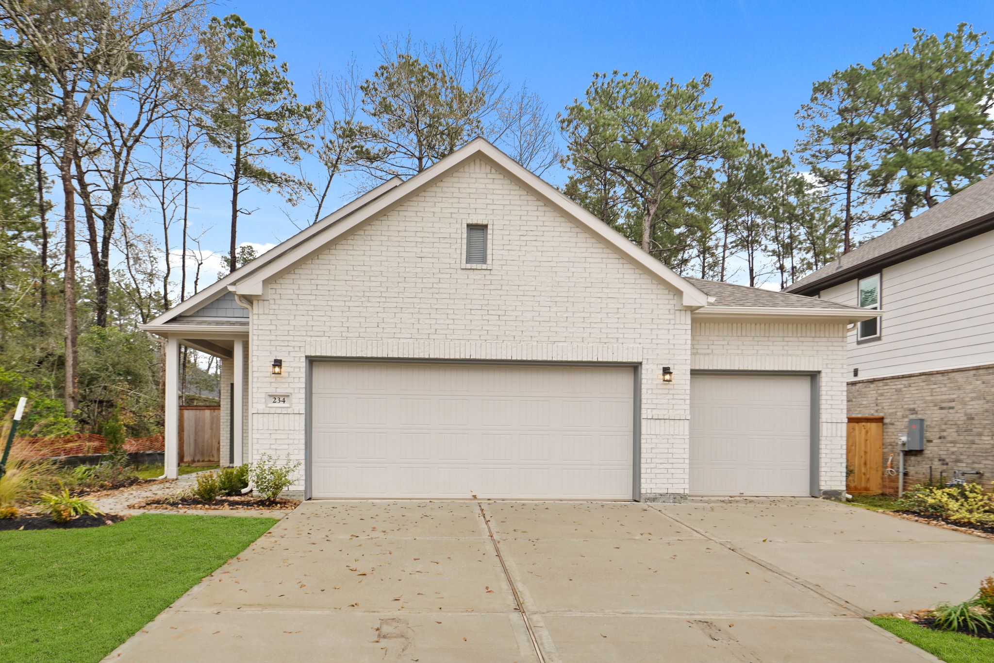 A house with garages and trees with American Gothic House in the background.