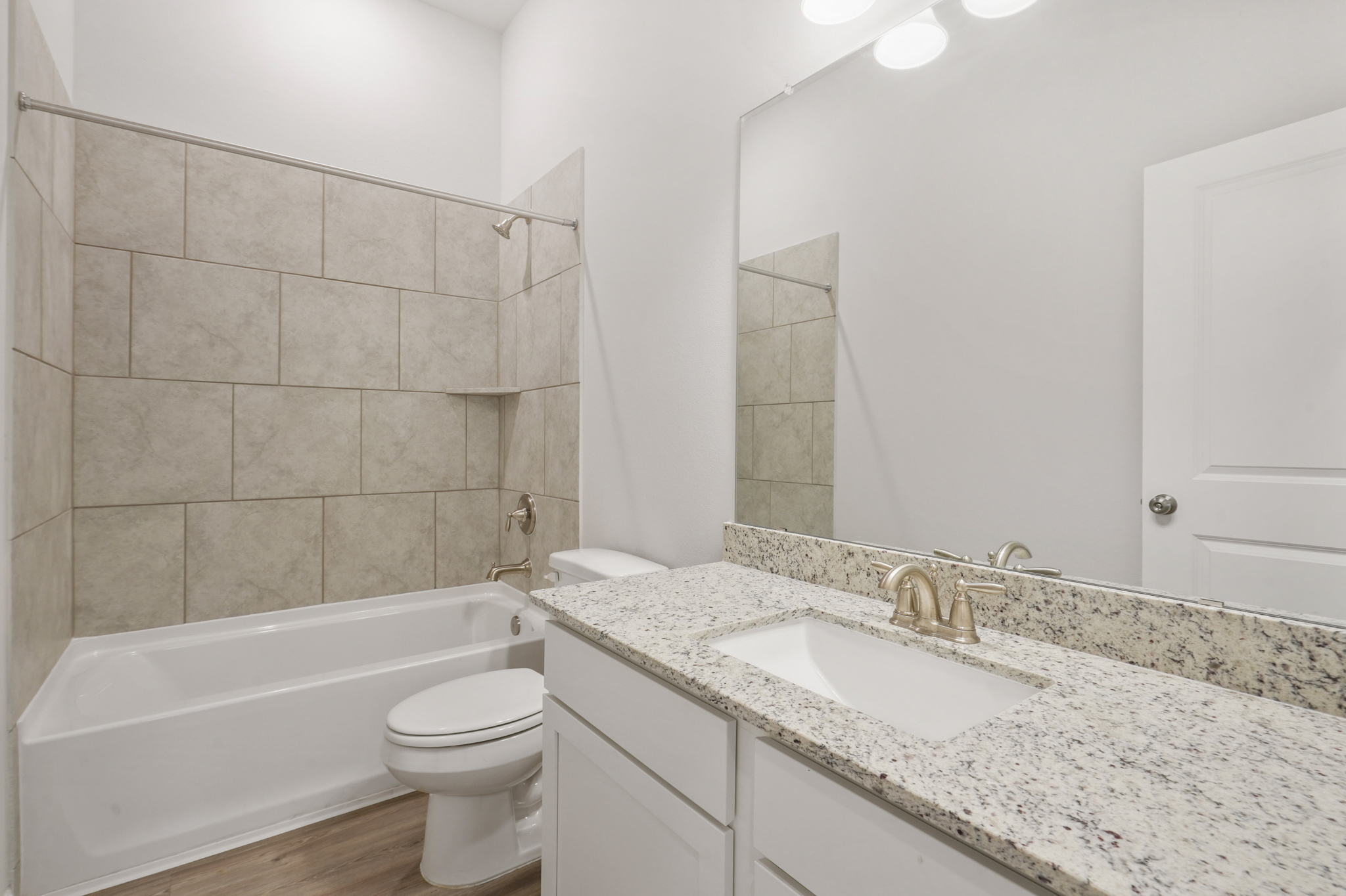 A bathroom with a marble countertop.