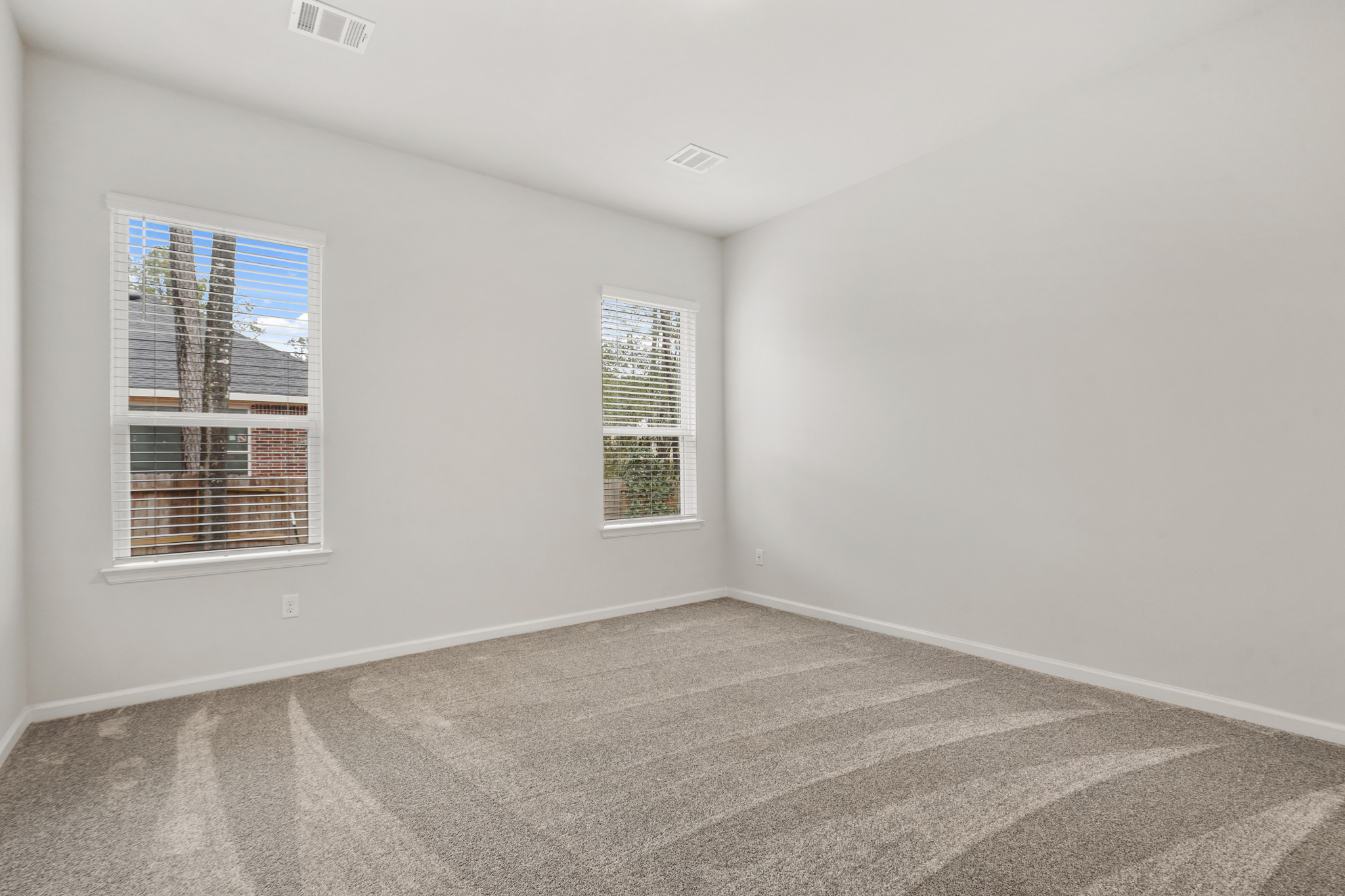 A room with a window and a carpet.