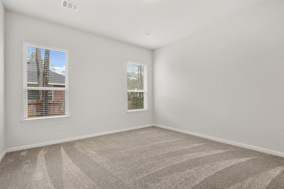 A room with a window and a carpet.