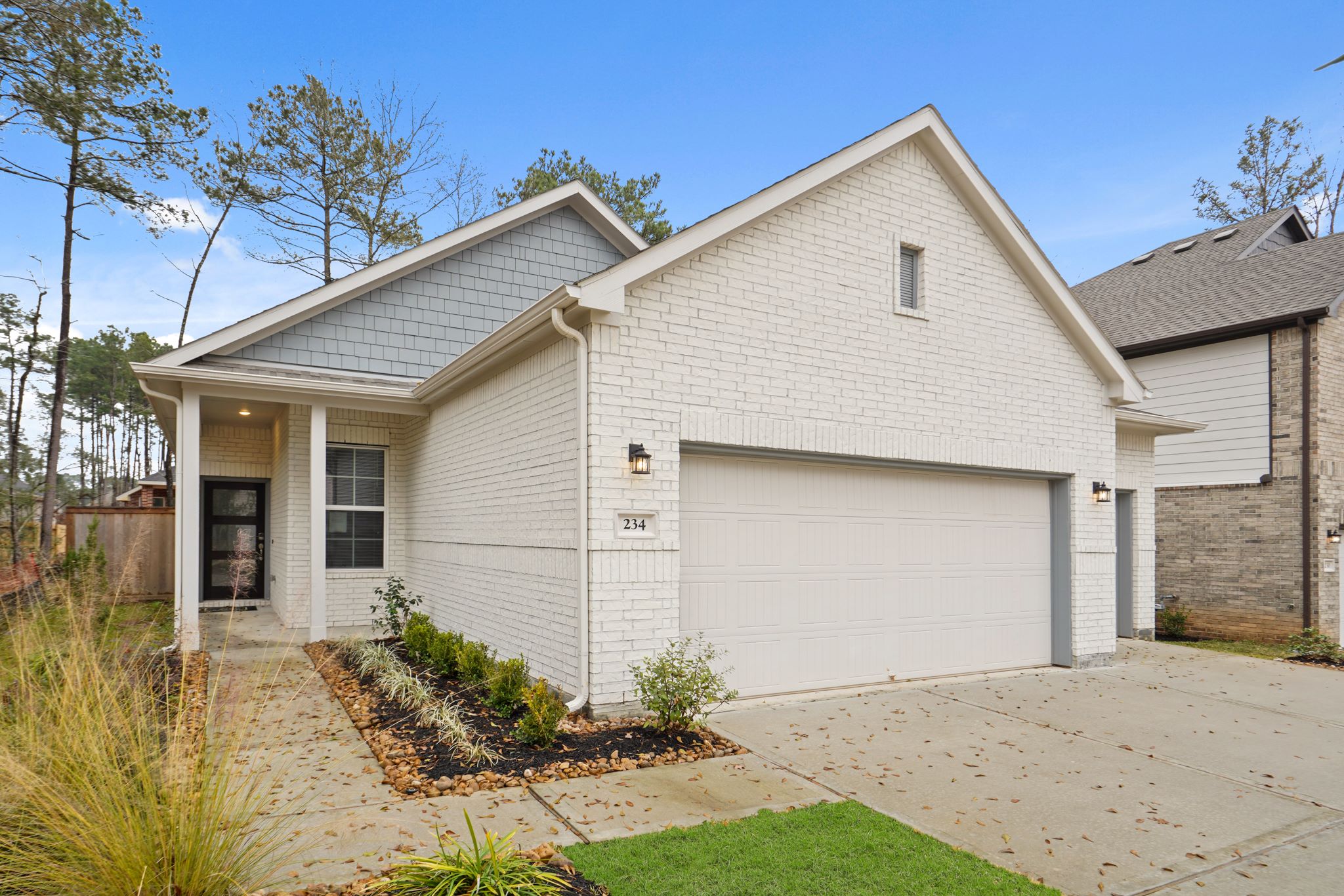 A white house with a garage.