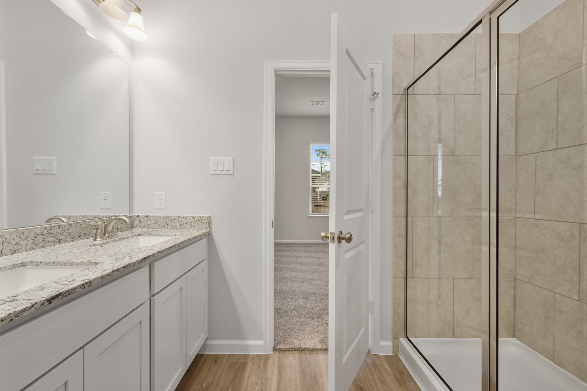 A bathroom with a shower and sink.