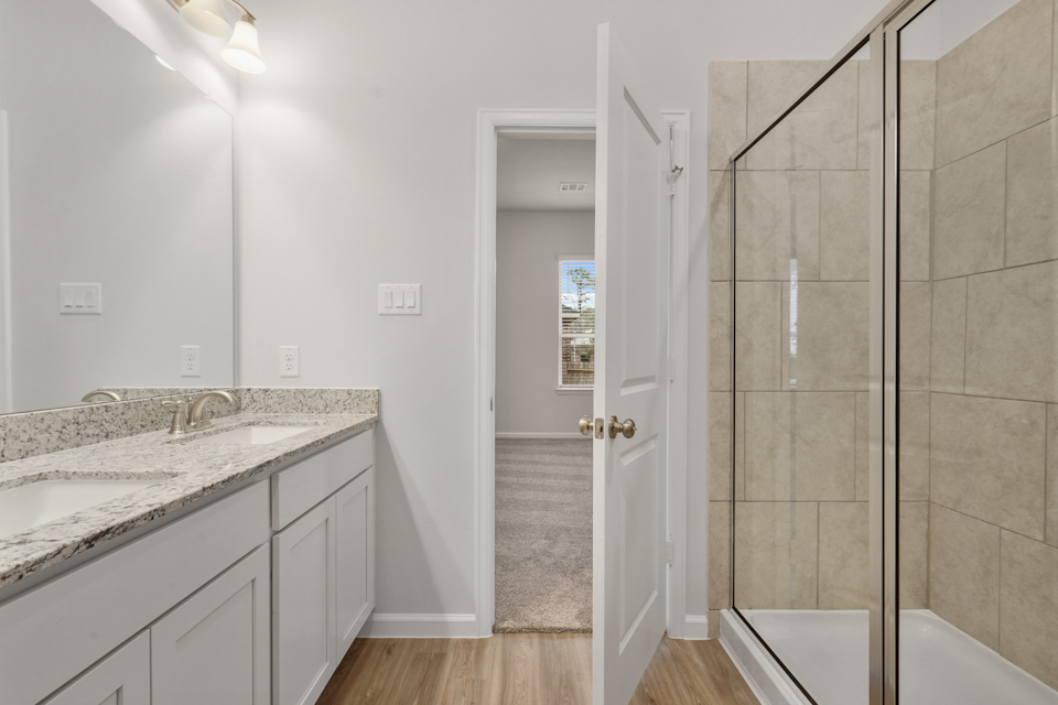 A bathroom with a shower and sink.