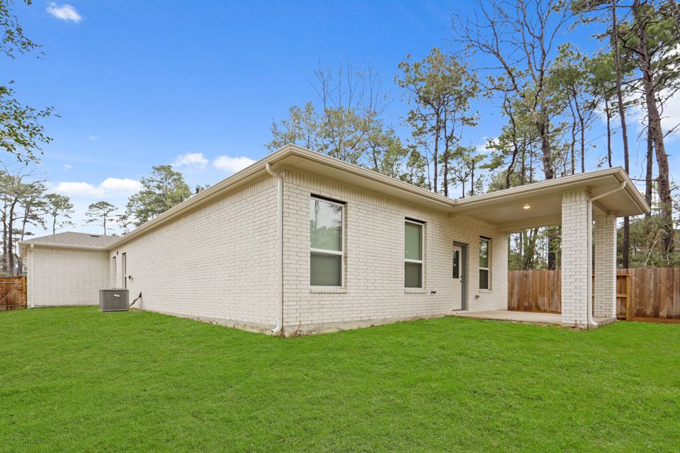 A house with a fence and trees.
