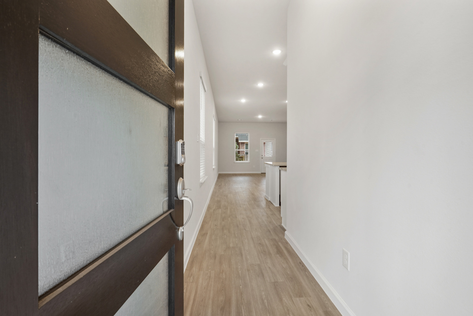 A hallway with a wood floor.