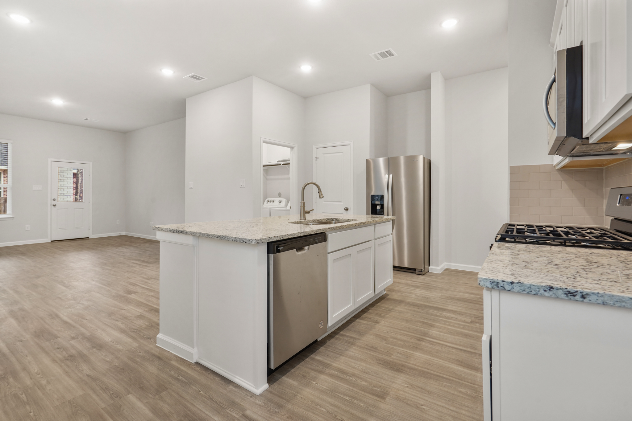 A kitchen with white cabinets.