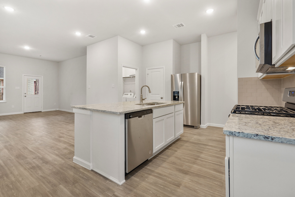 A kitchen with white cabinets.