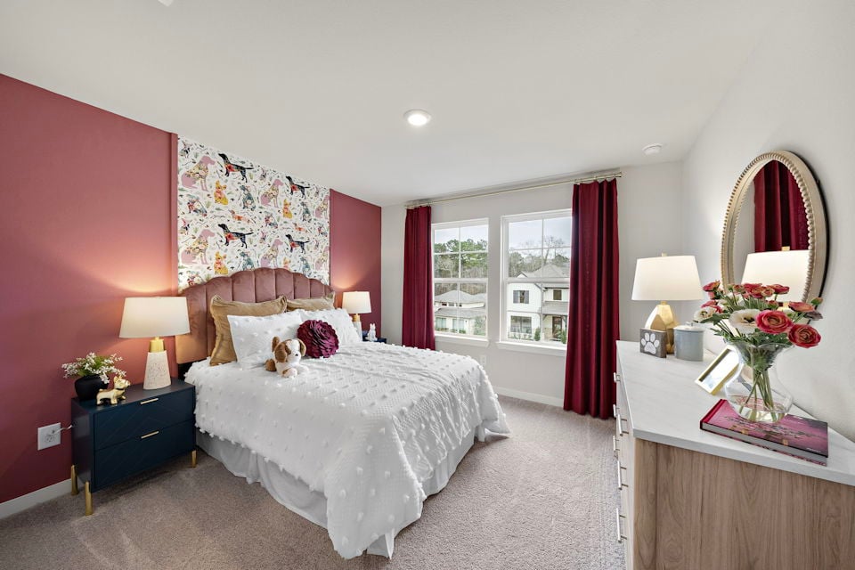A bedroom with pink walls.