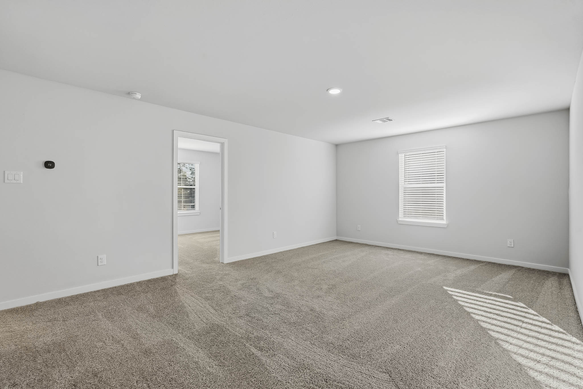 A room with a carpet and a rug.