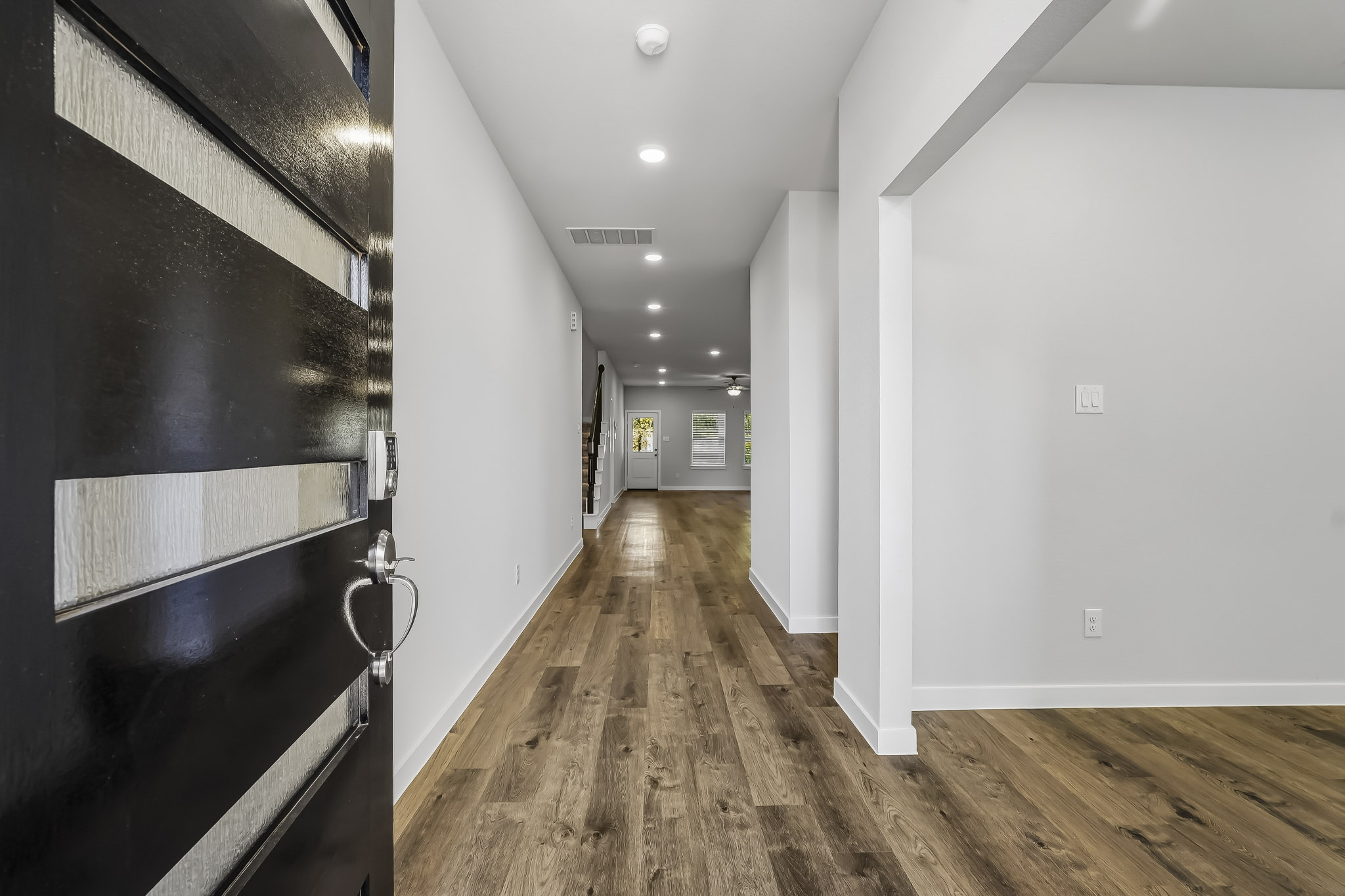 A hallway with white walls.