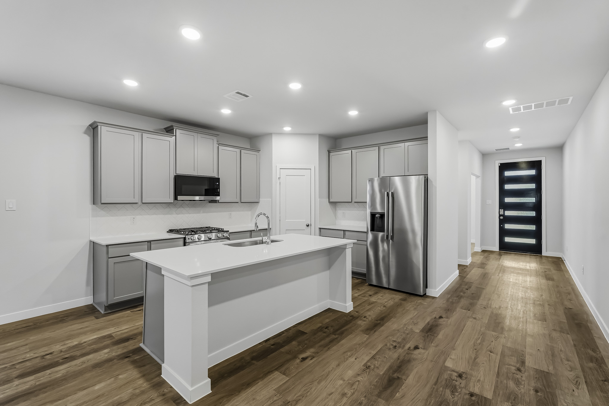 A kitchen with white cabinets.