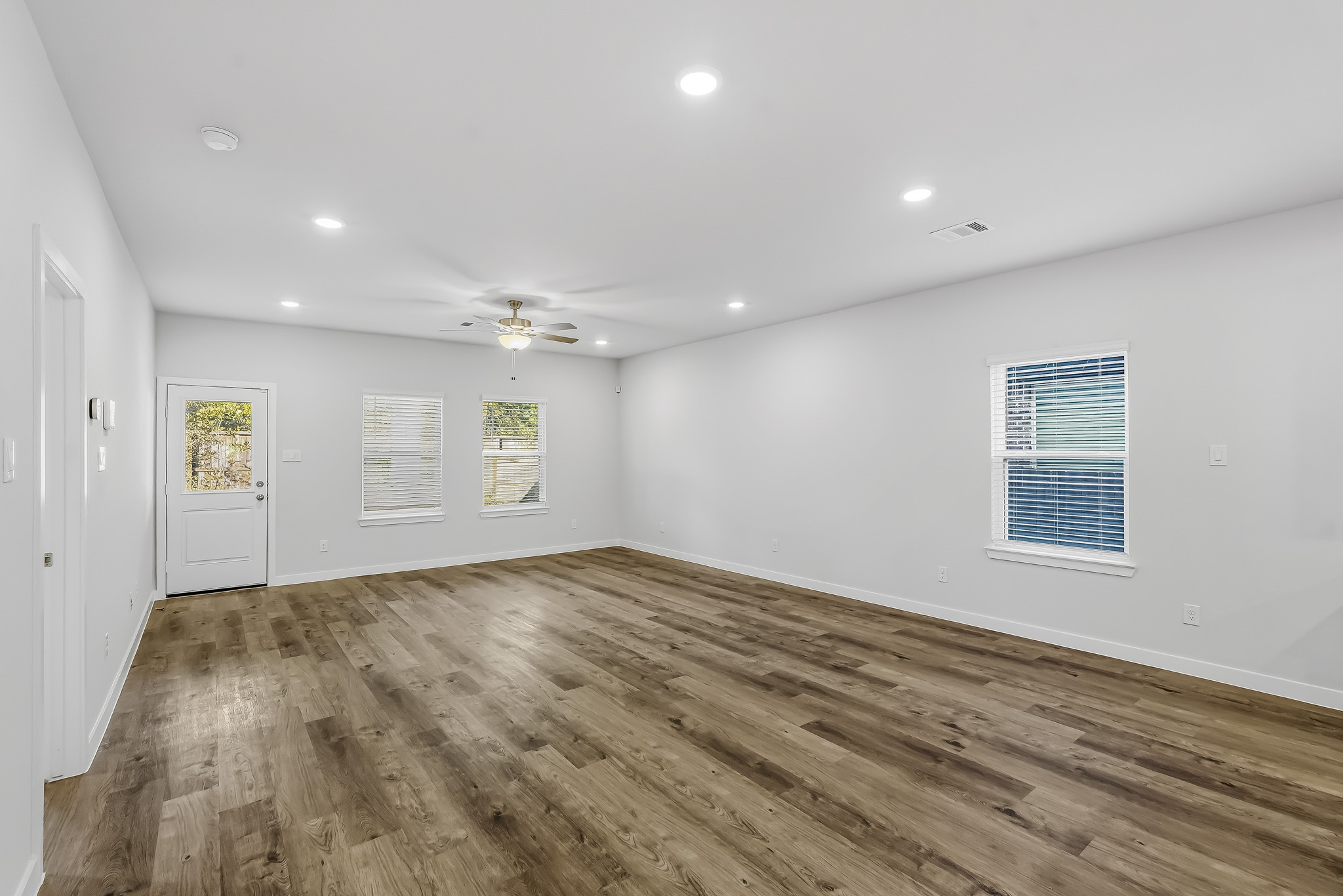 A room with a wood floor and a wood floor.