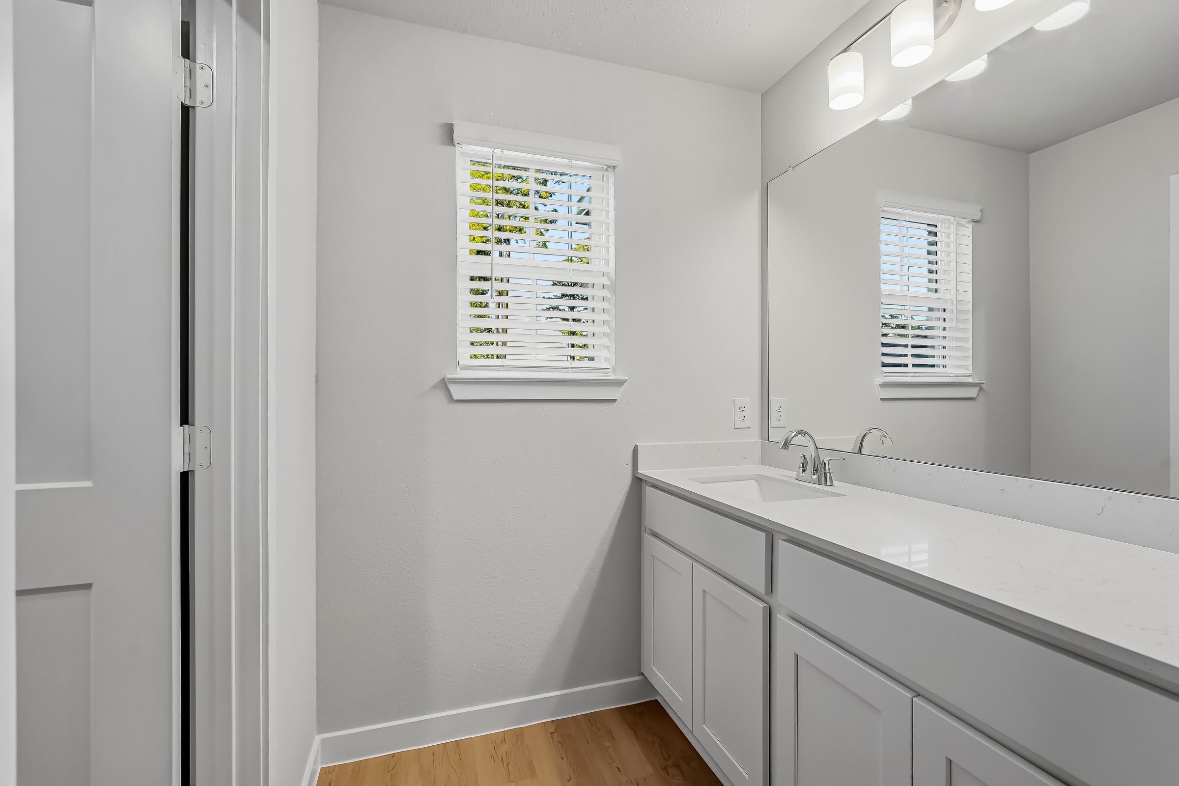 A bathroom with a sink and a mirror.