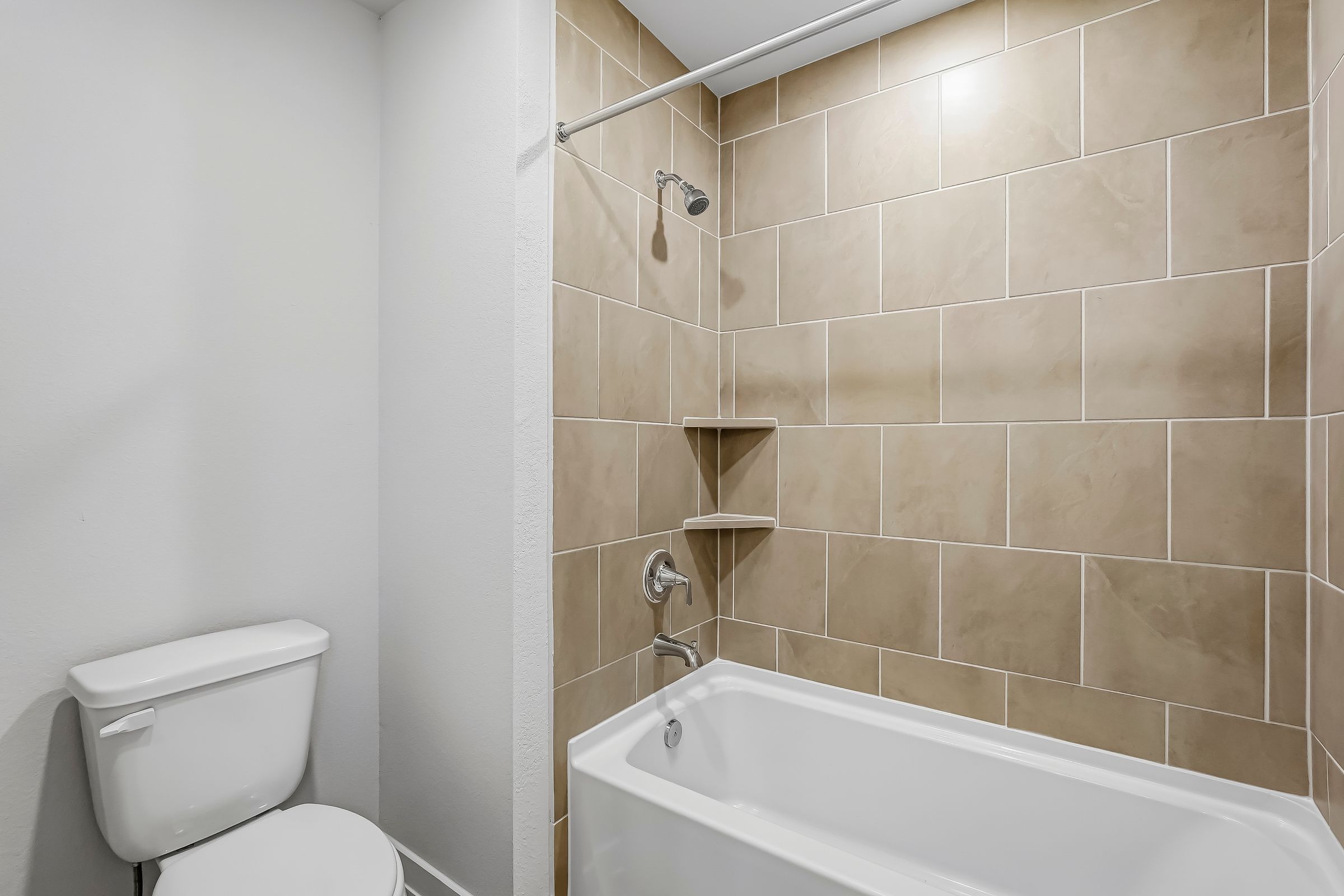 A bathroom with a tub toilet and sink.