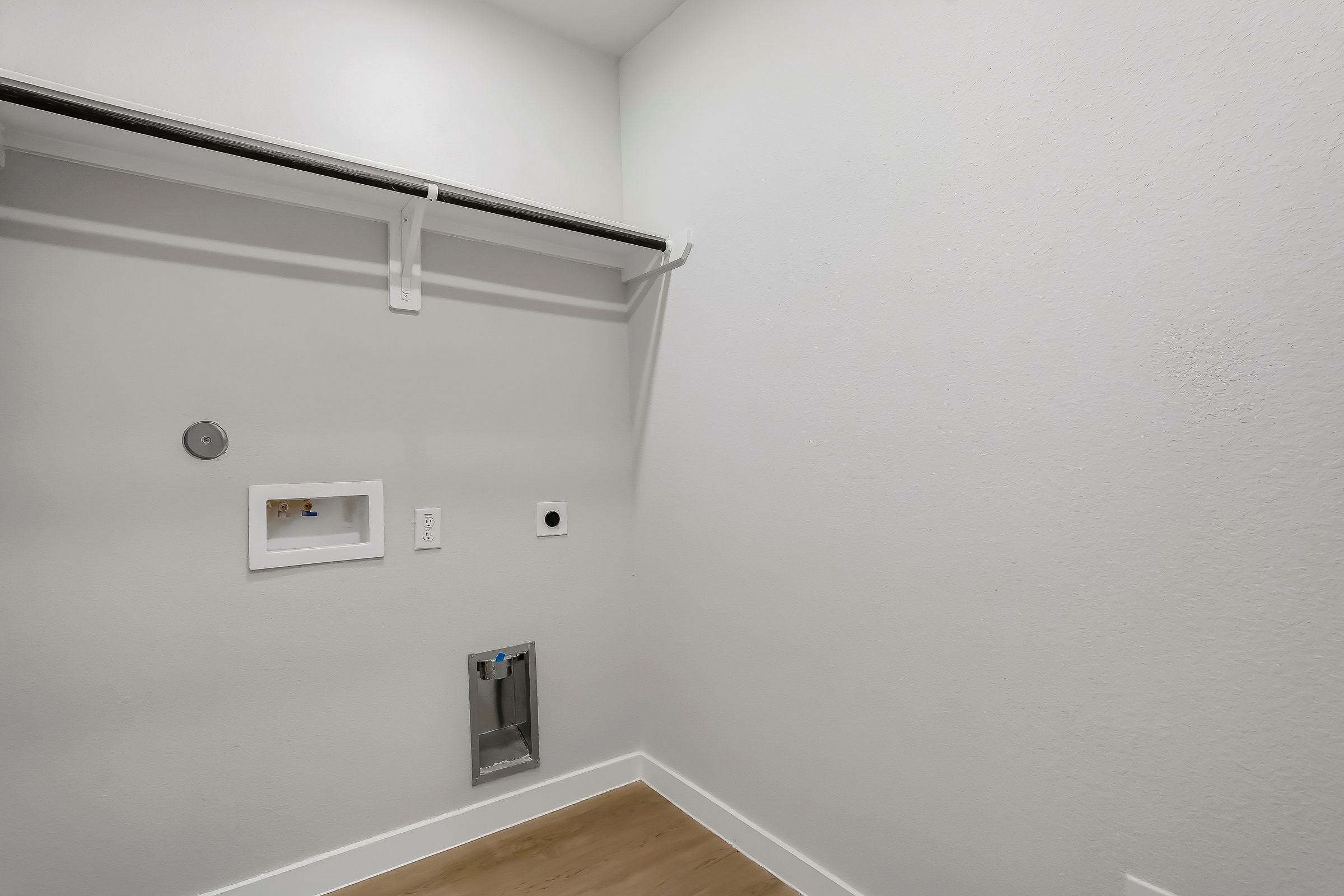 A white wall with a light fixture.