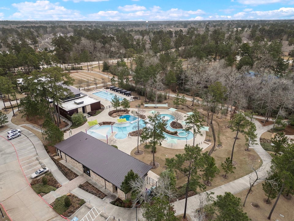 A large swimming pool surrounded by trees.