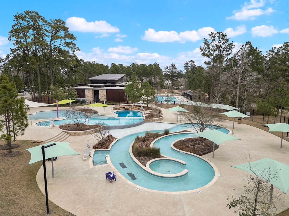 A pool with a building in the background.