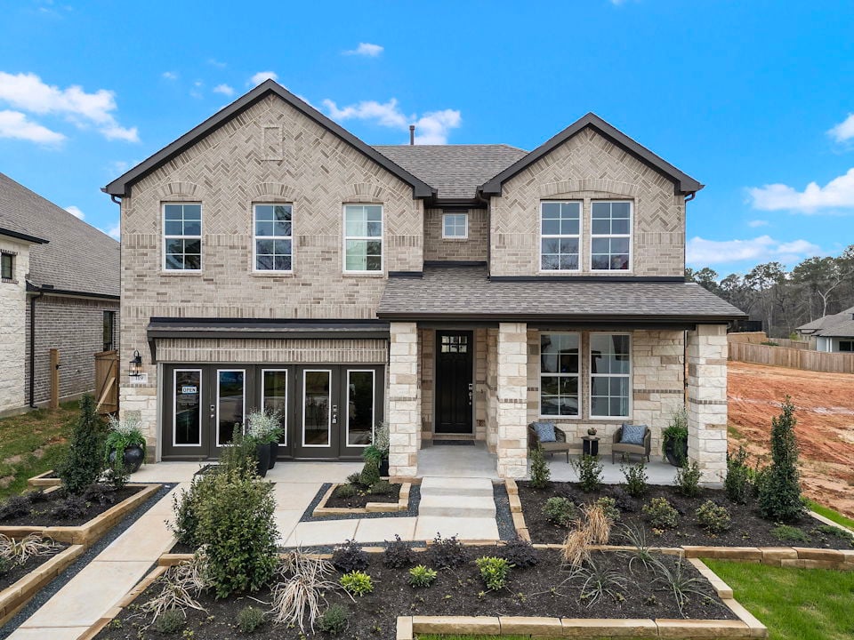 A stone house with a stone driveway.