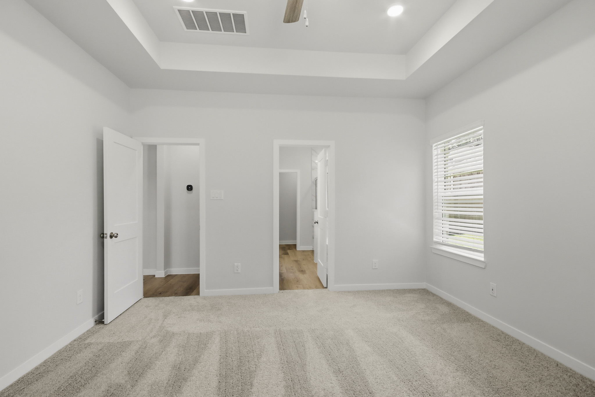 A hallway with white walls.