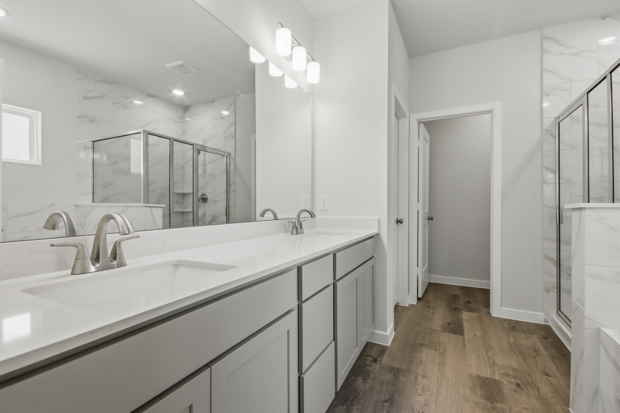 A bathroom with a large mirror.