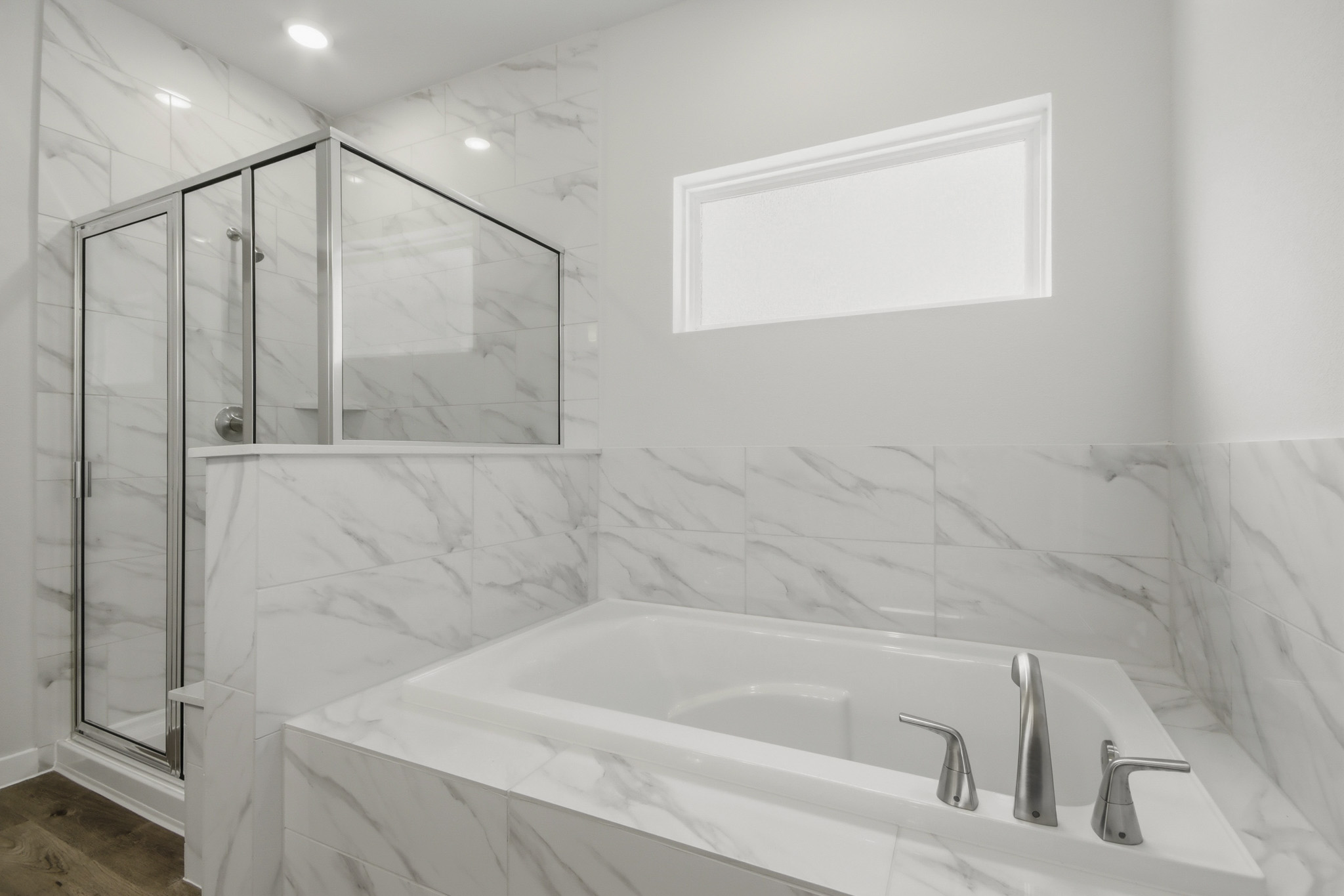A bathroom with a glass shower.
