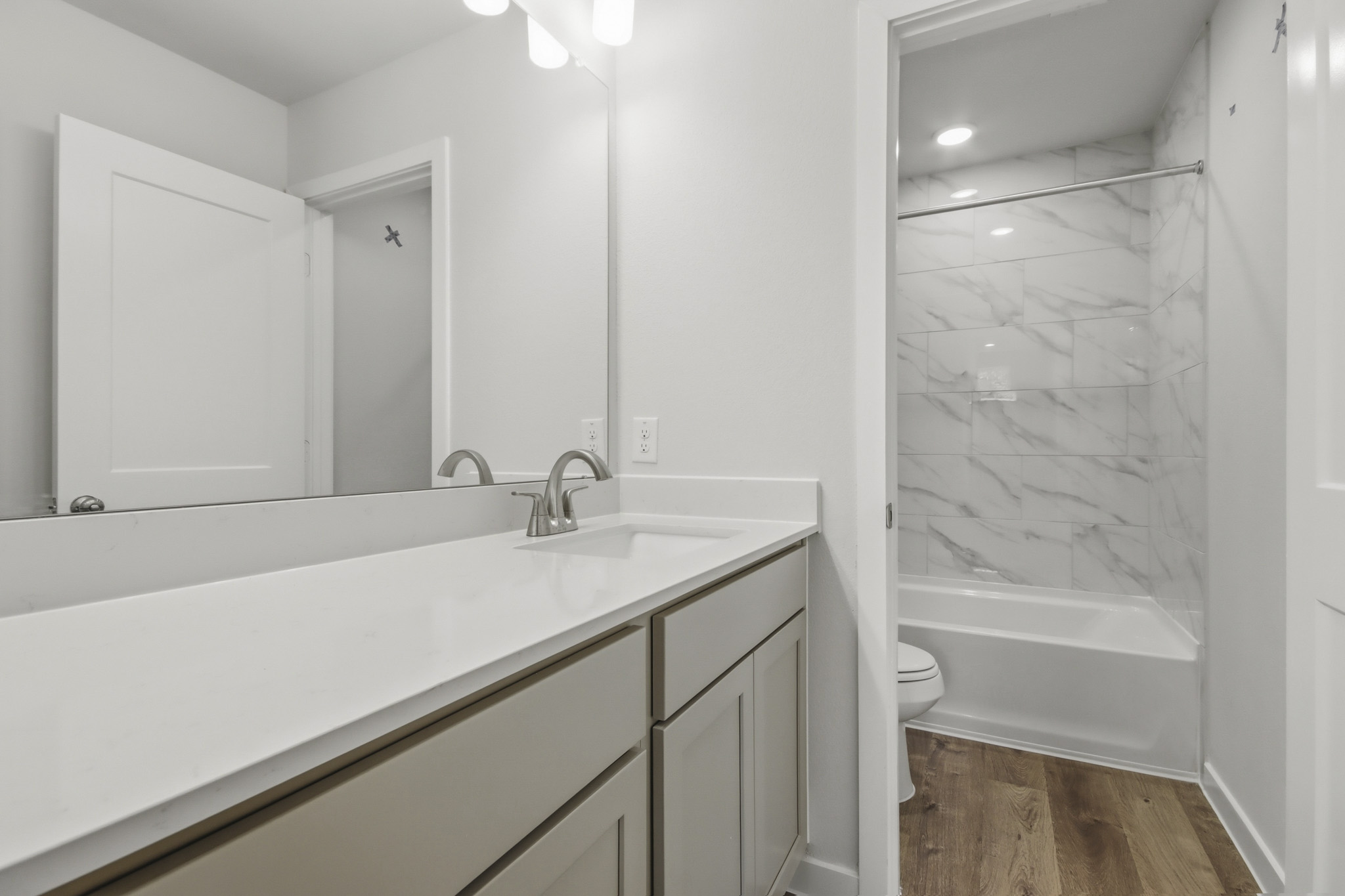 A bathroom with a tub sink and toilet.