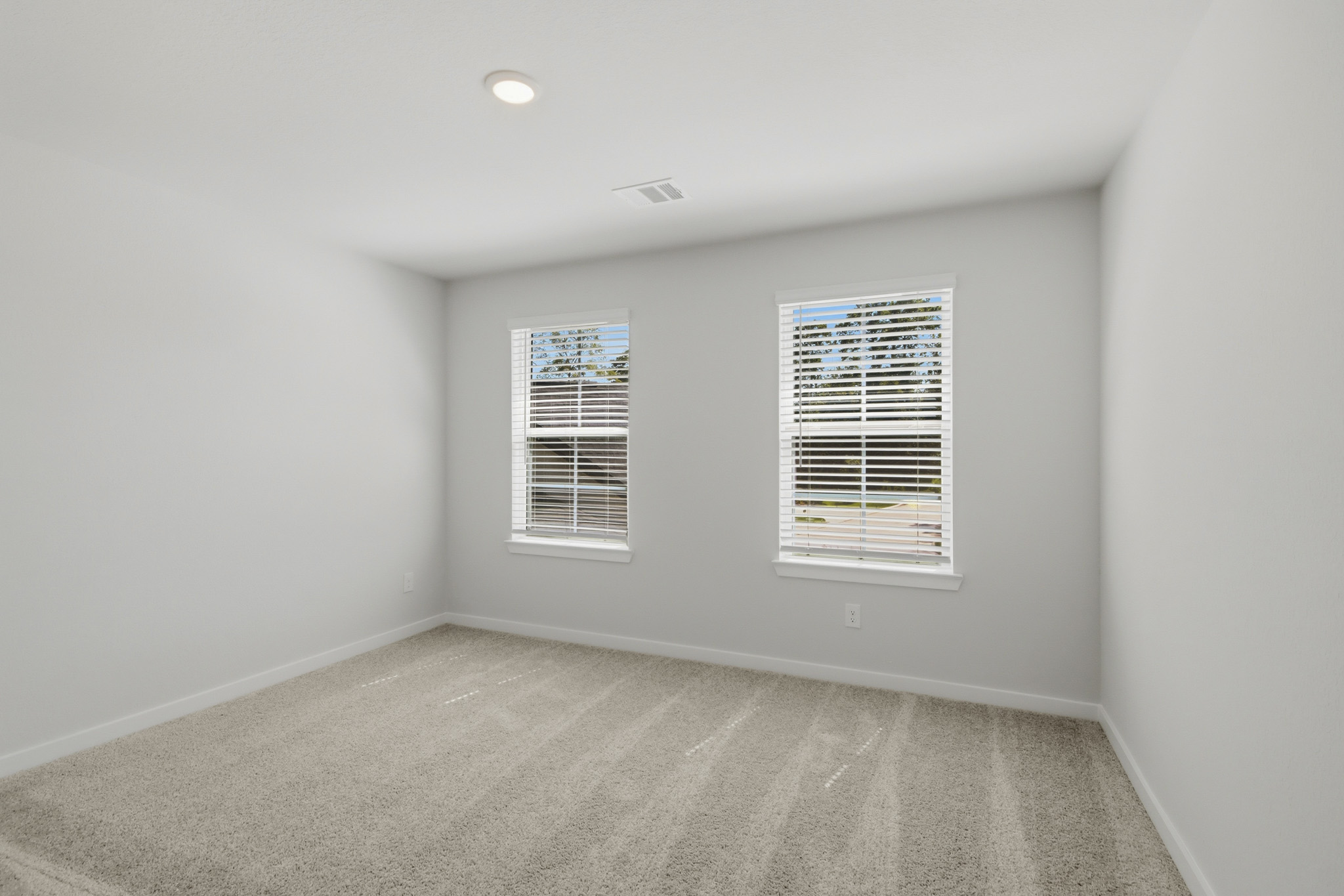 A room with a window and a carpet.
