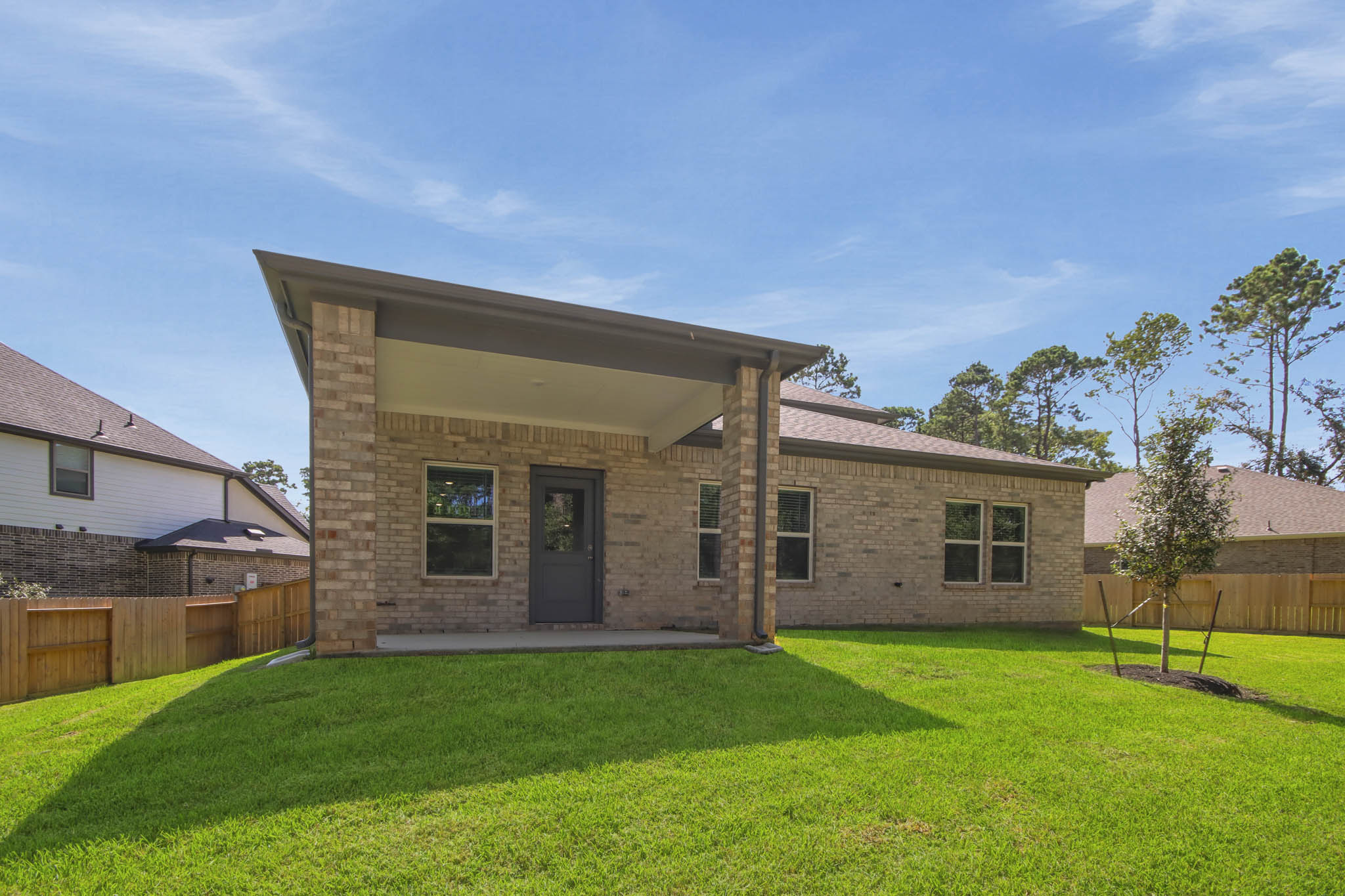A house with a fence and grass.
