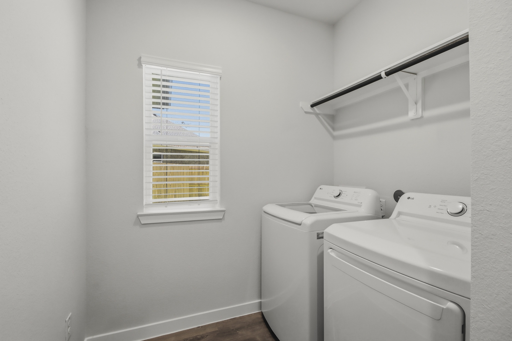 A washing machine and a dryer in a room.