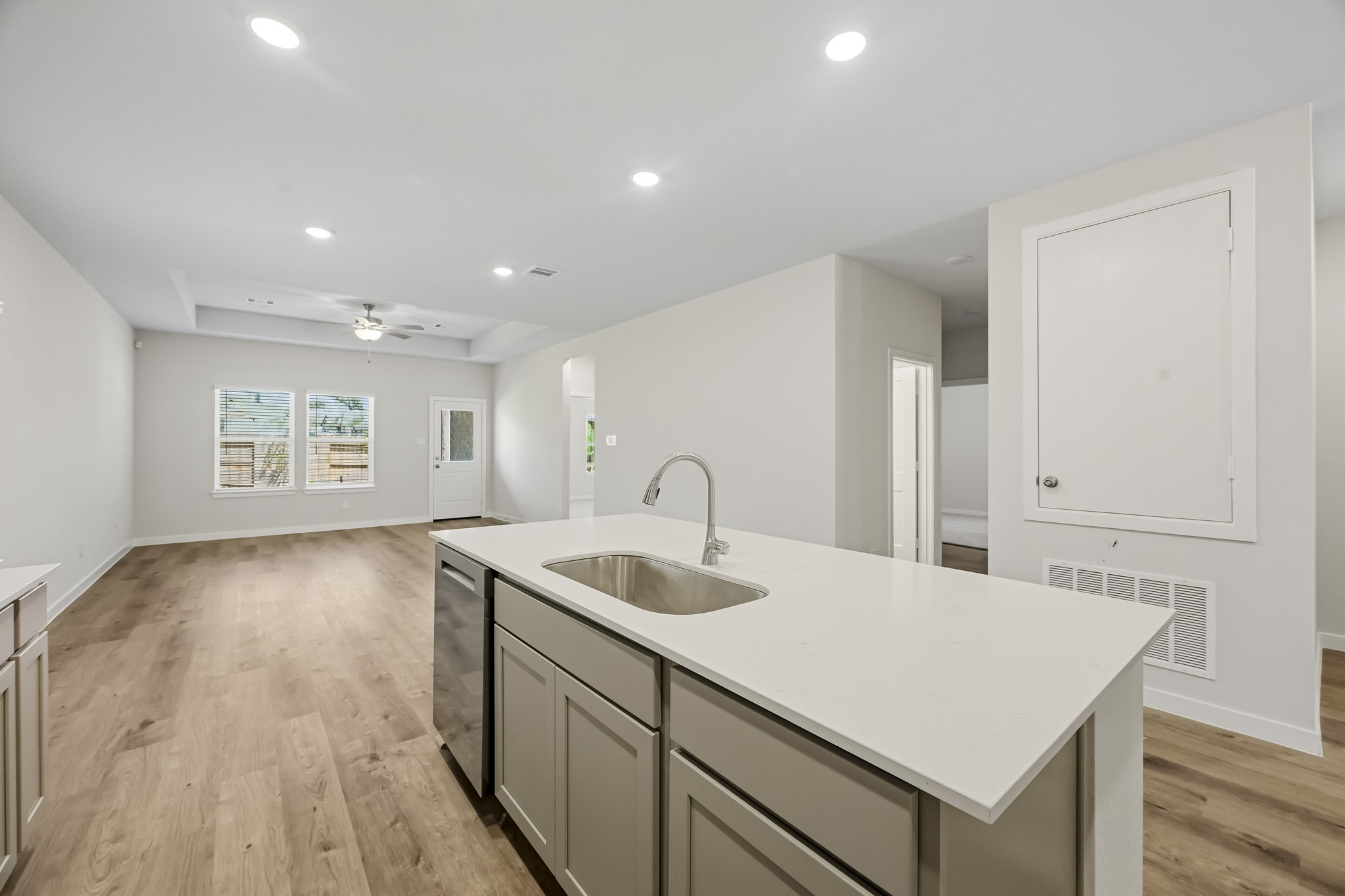 A kitchen with white cabinets.