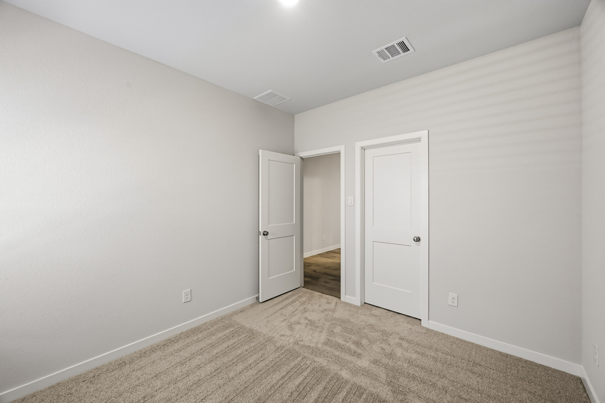 A hallway with white doors.