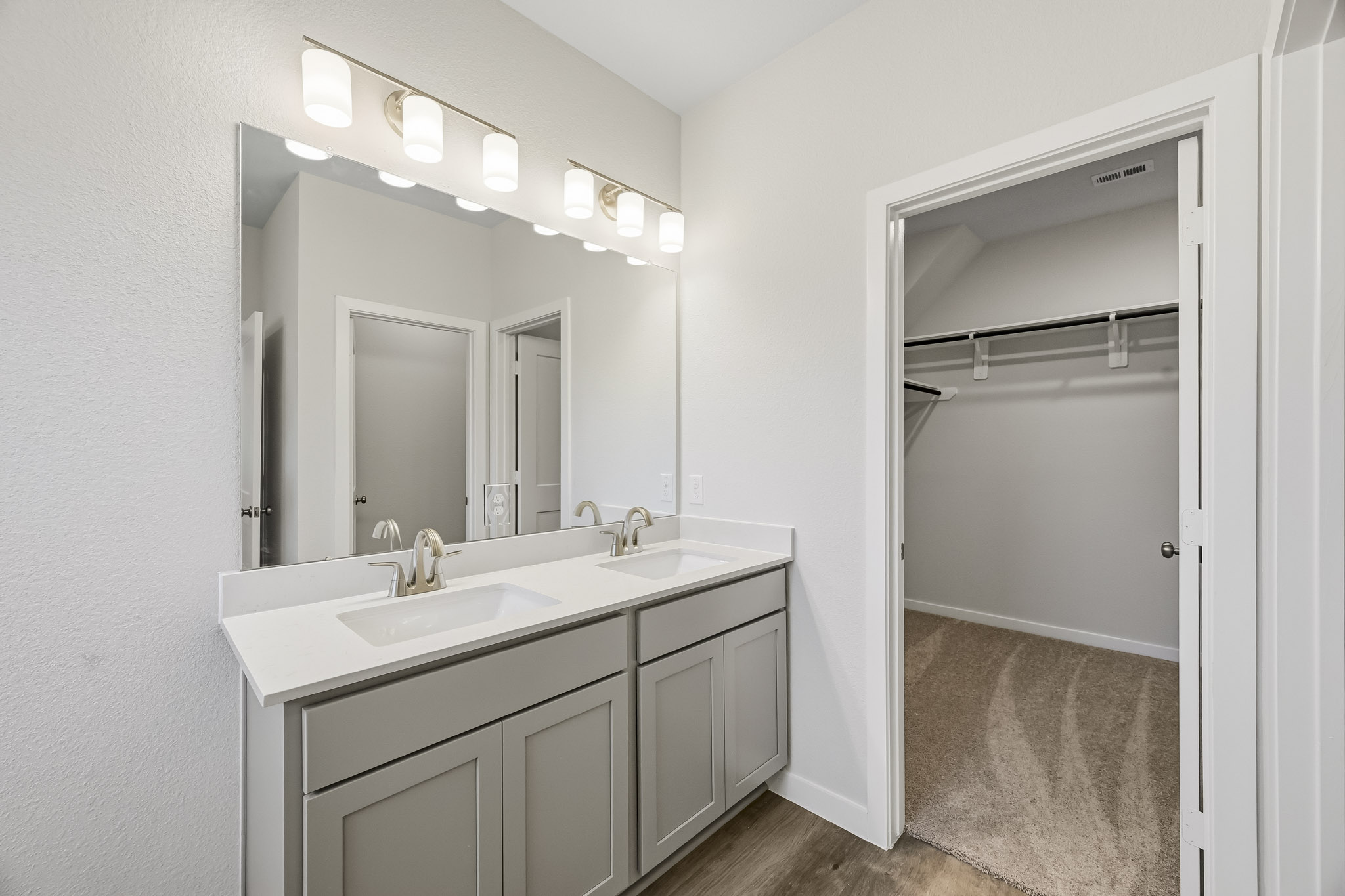 A bathroom with a sink and a shower unit.
