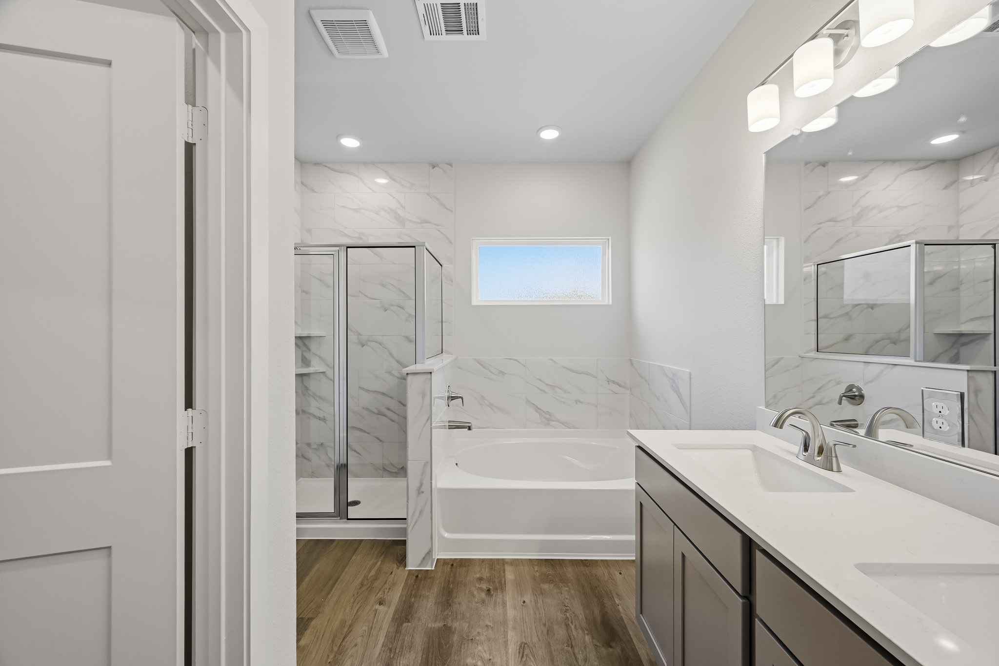 A bathroom with a tub sink and a shower.