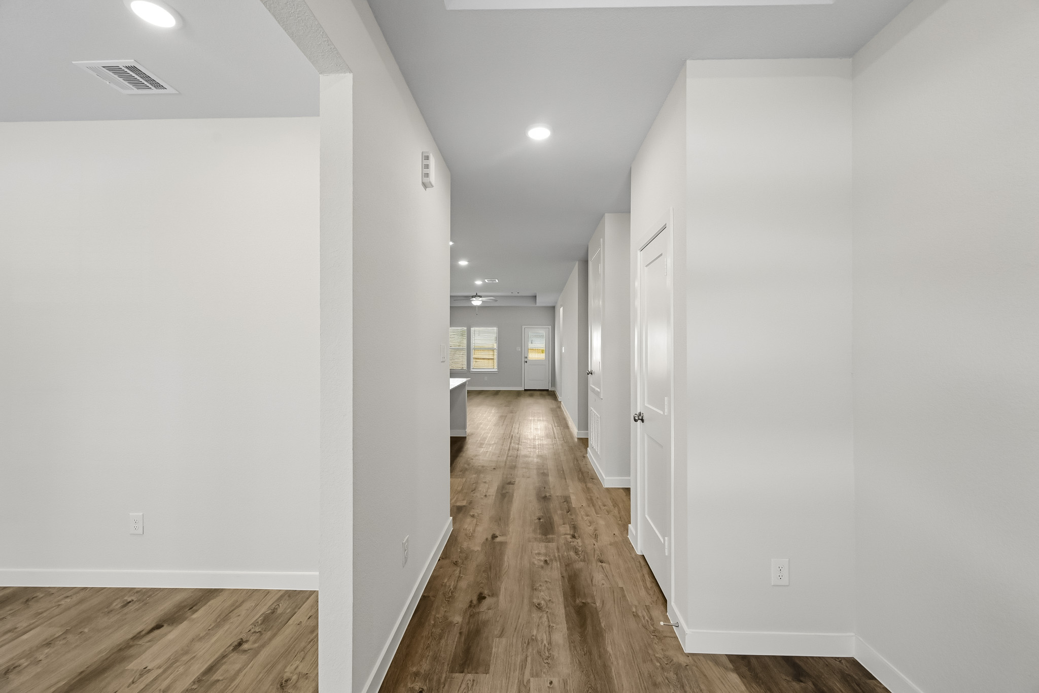 A hallway with white walls.