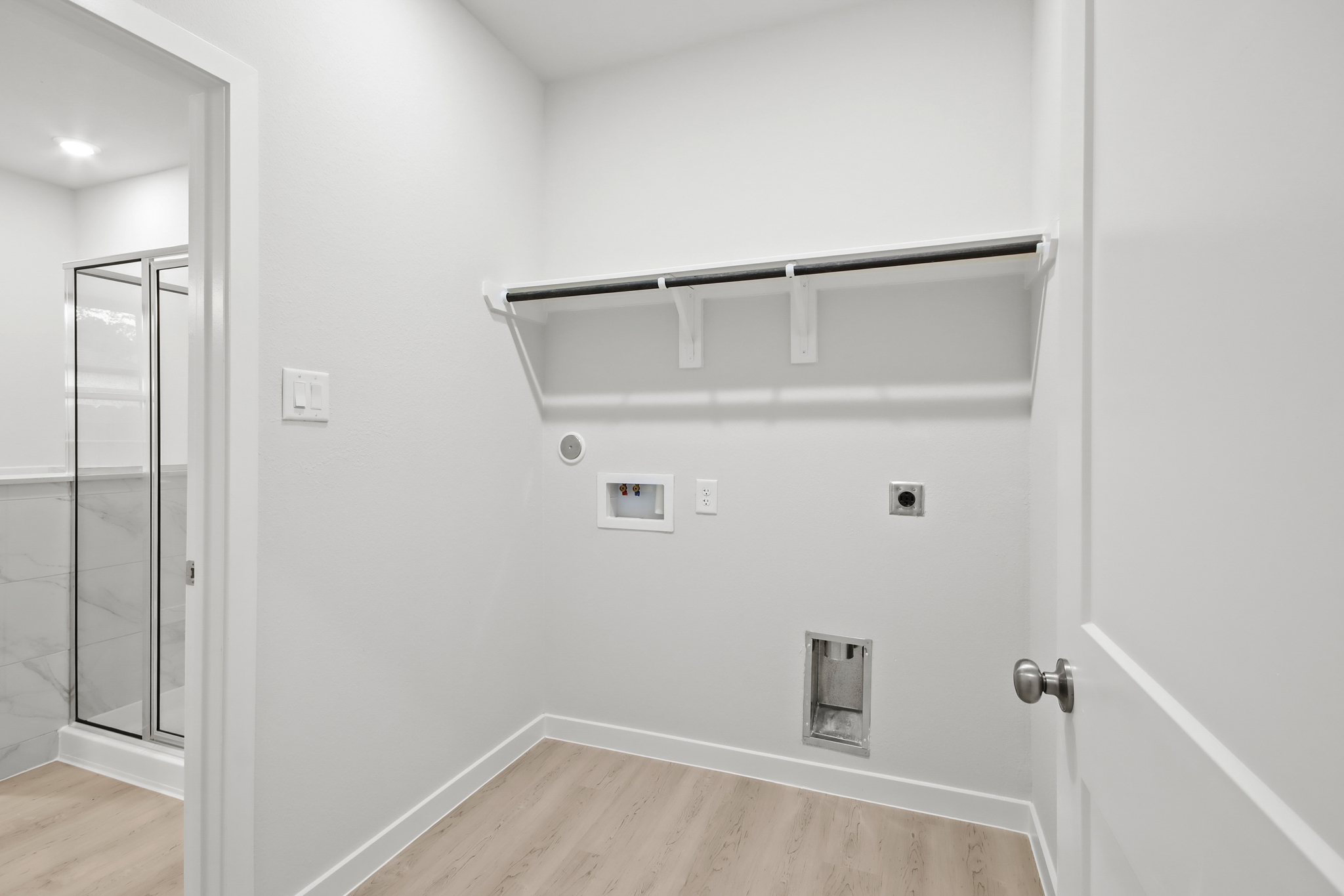 A white room with a glass door.