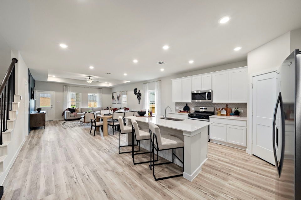 A kitchen with white cabinets.