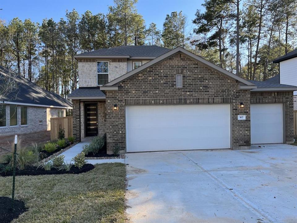 A house with garages and trees.